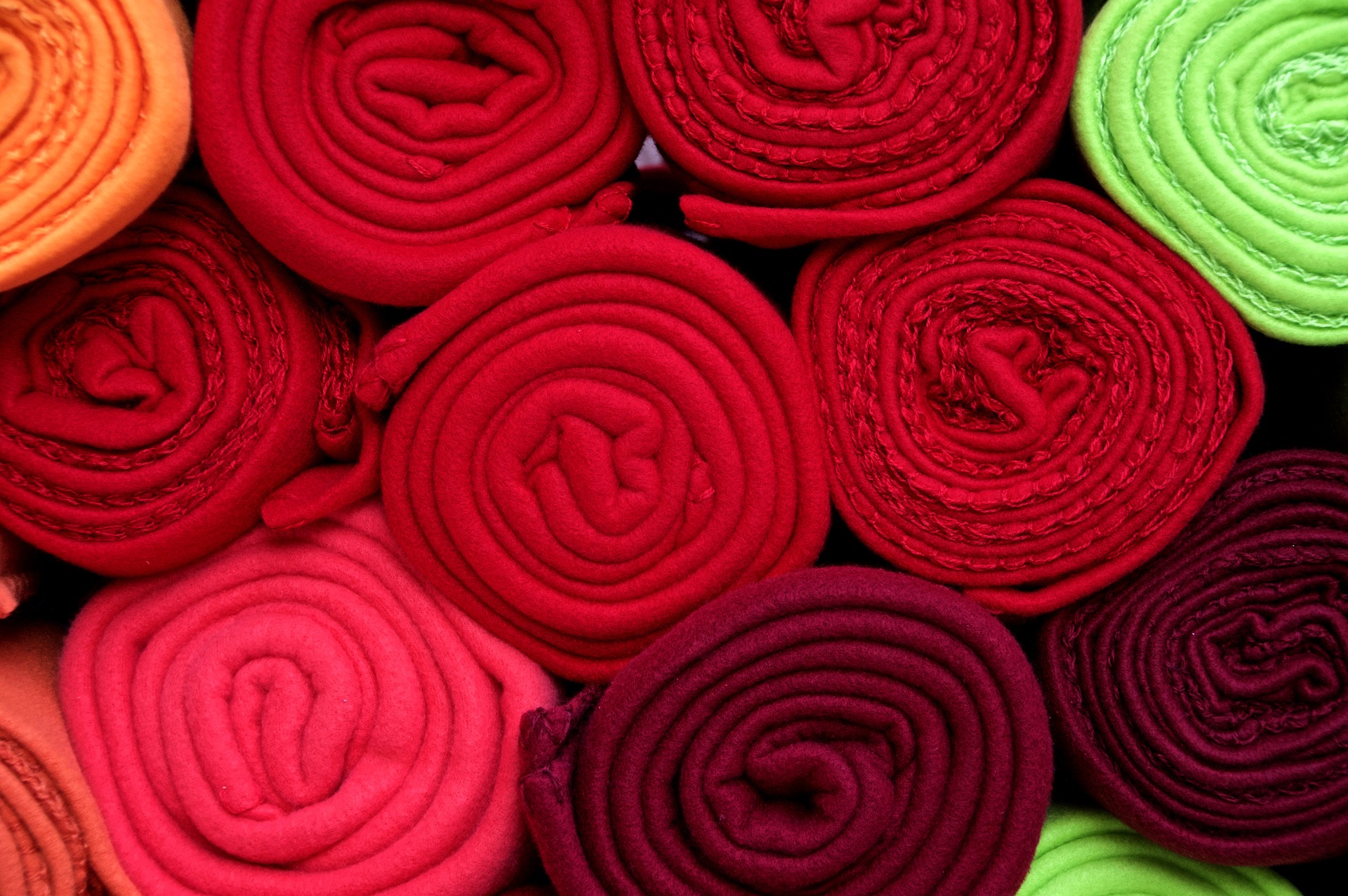 Image of rolled up fabric stacked on top of each other
